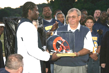 RM football coach saluted by former school